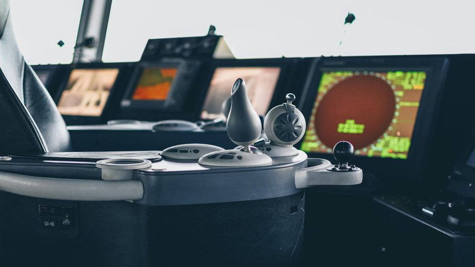 An air traffic control room with multiple radar and monitoring displays.