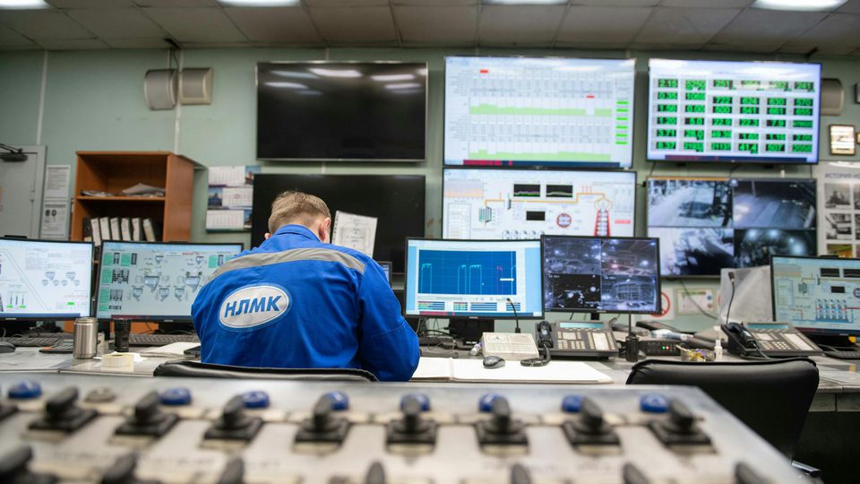 An engineer working in a control room with multiple monitoring screens, used as a lead visual for a radar, EO, and RF integration article.